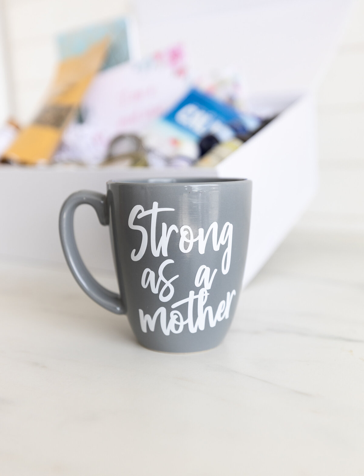 Grey mug that says strong as a mother