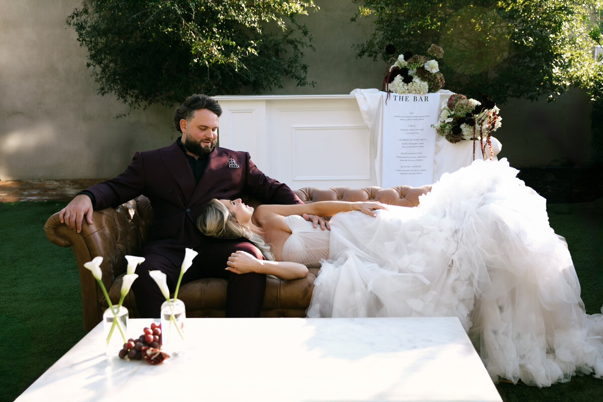 editorial pose by photographer of bride and groom on wedding day outside