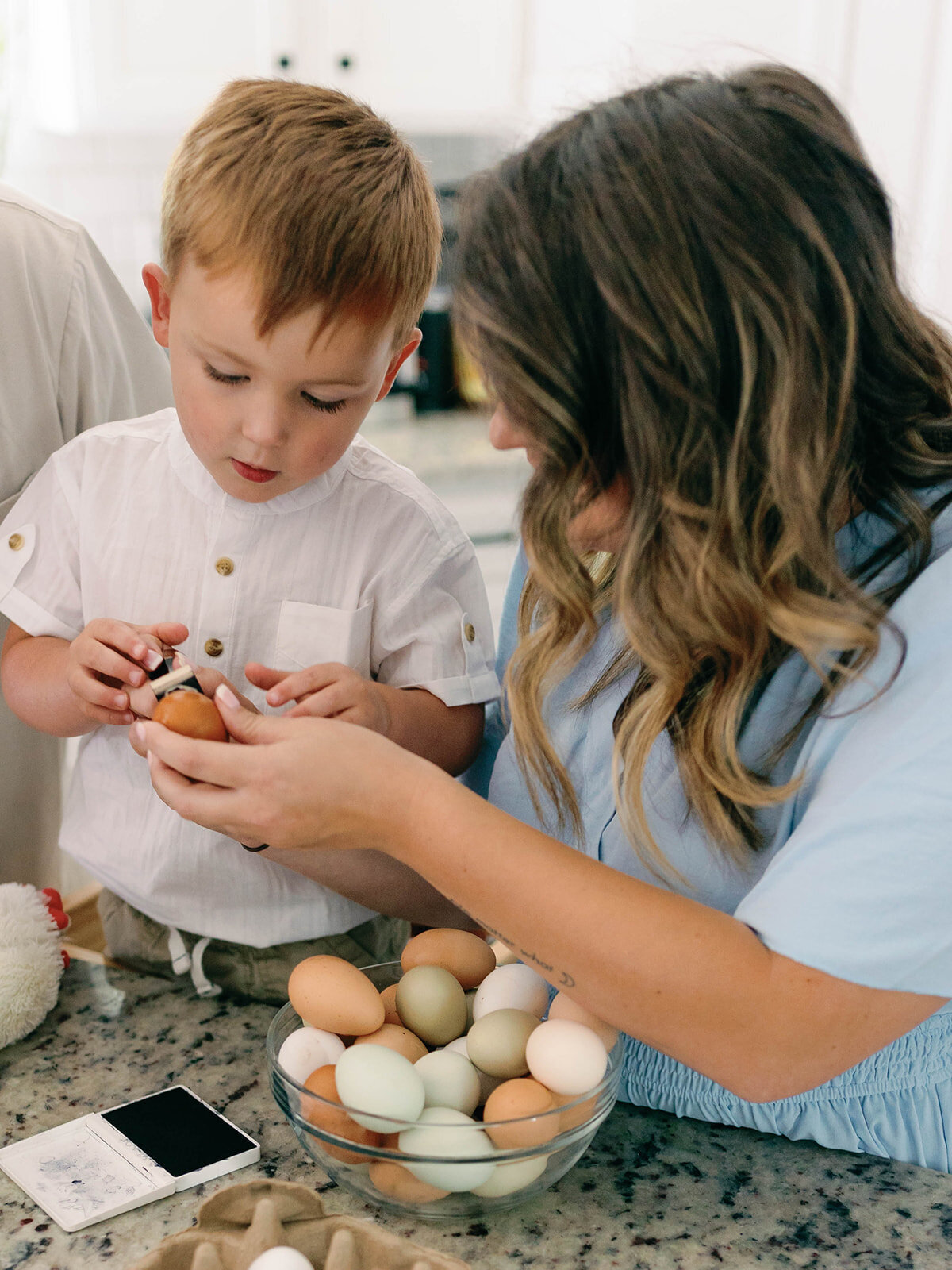 Mom and son stamping eggs