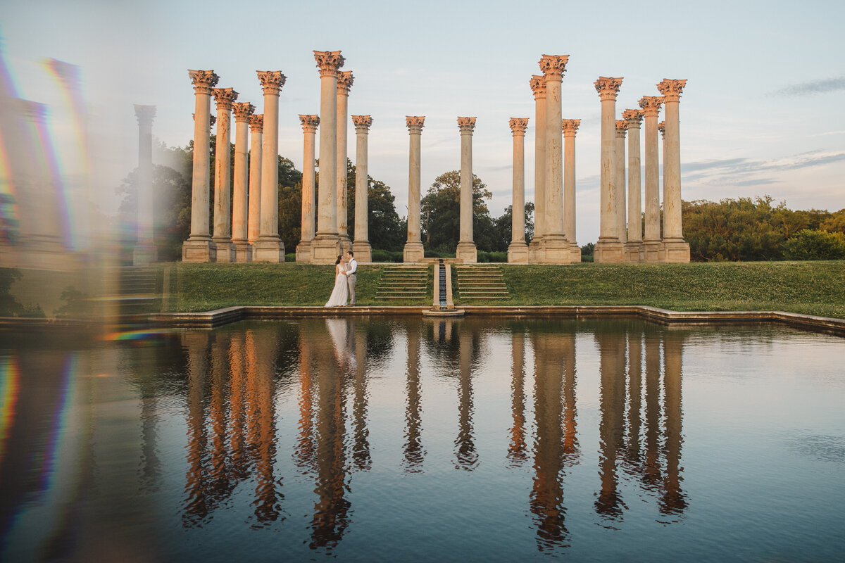 View of a newlywed couple from across a pond at the National Arboretum 