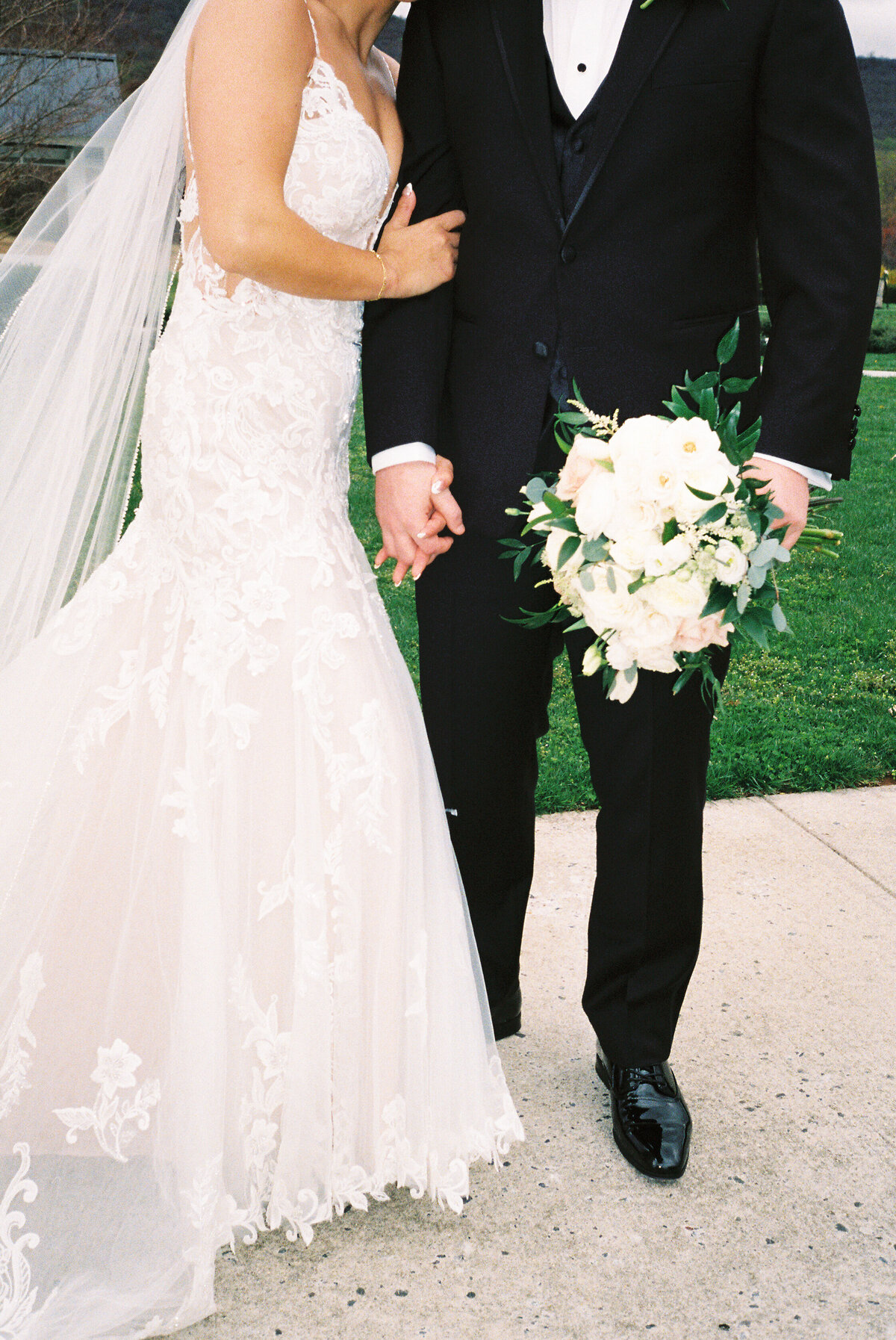 Film photograph of bride and groom holding hands