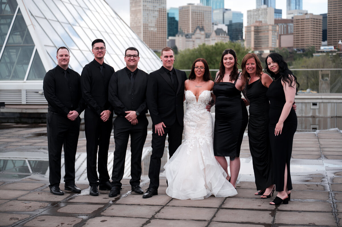 wedding party standing outside of the Muttart Conservatory pyramids