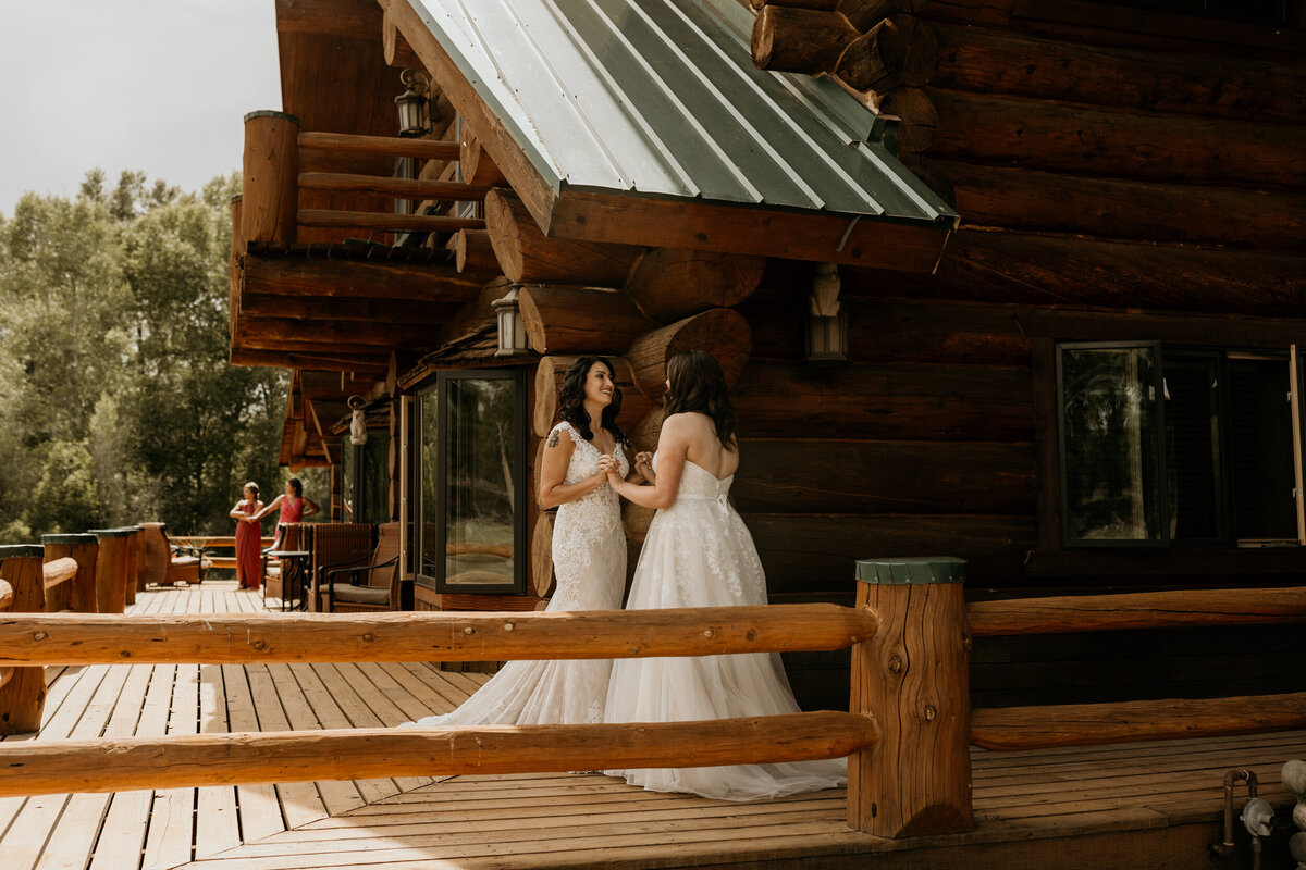 same sex couple in their wedding dresses having  a first look