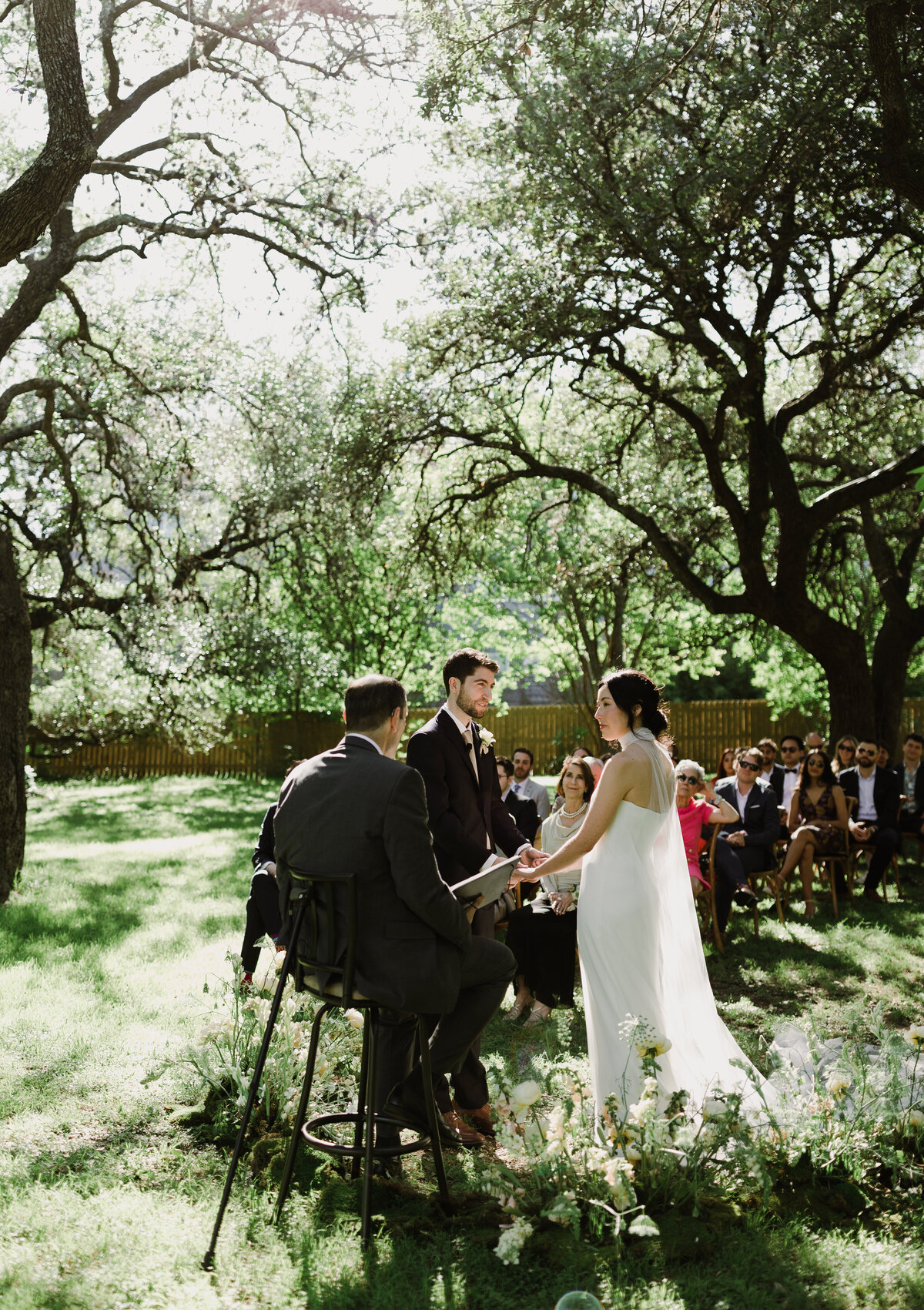 Bride and groom exchanging vows at outdoor wedding ceremony at  Mattie's Austin