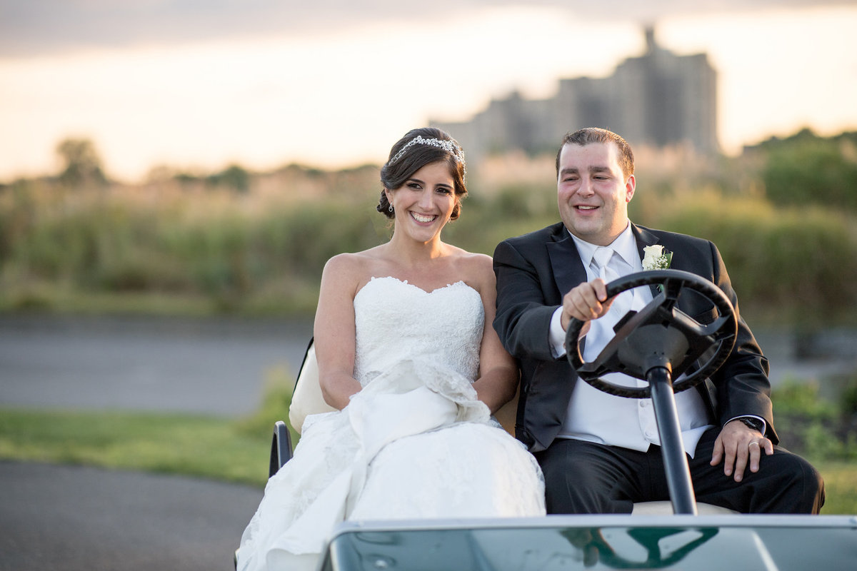 photo of bride and groom driving in cart from wedding at Lawrence Yacht and Country Club