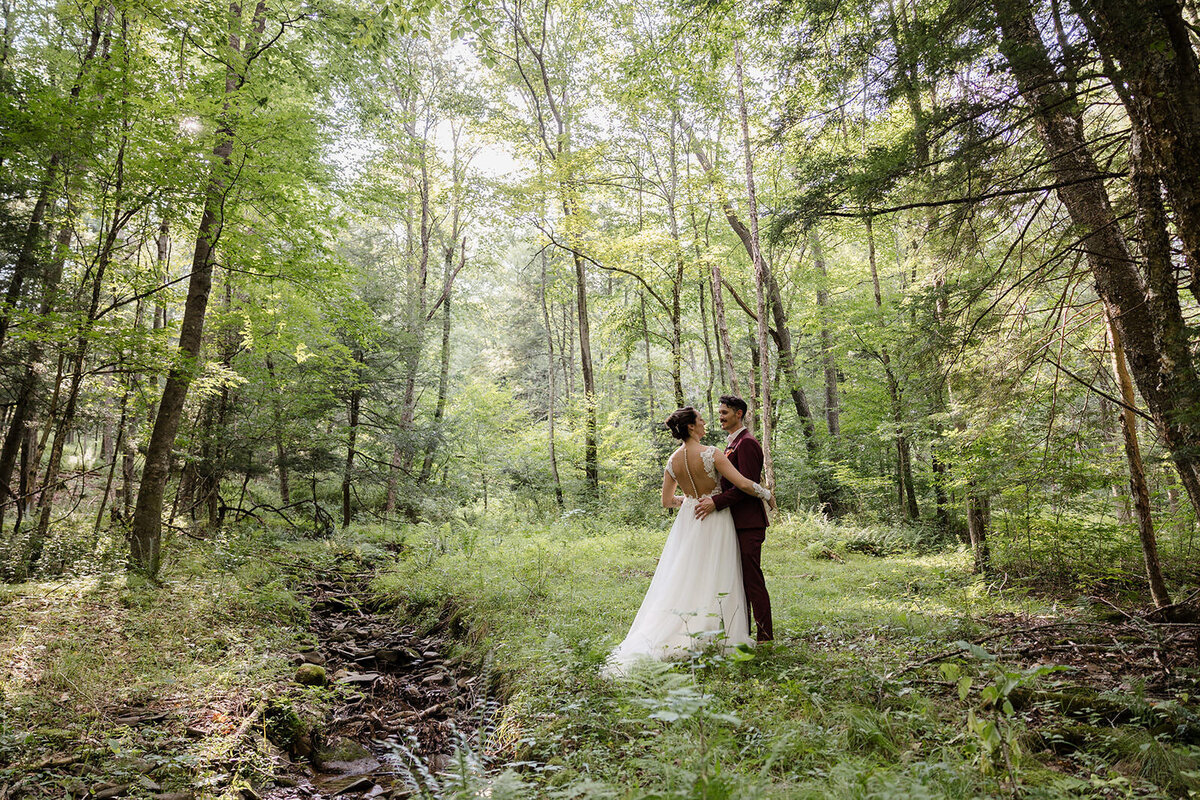A couple dancing in a small wooded area