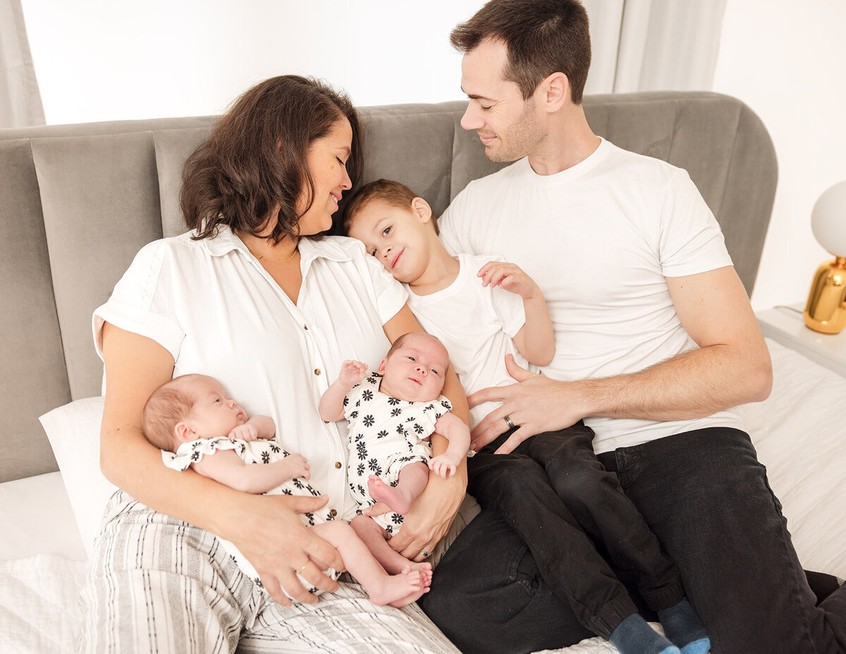 Mother holding newborn during in-home lifestyle photo session in Central Florida

