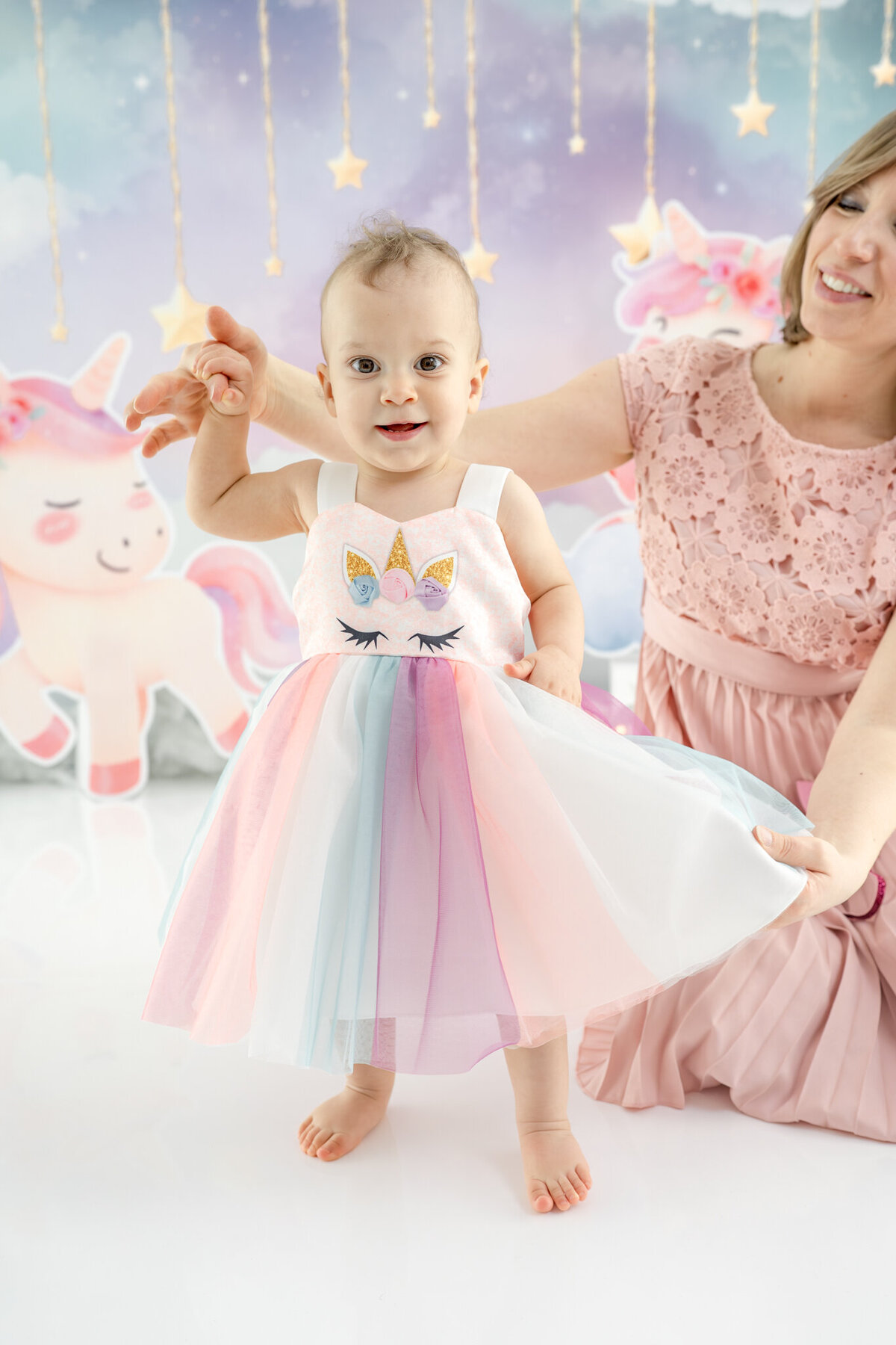 Girl in unicorn dress during themed cake smash session— captured by Alliston and Barrie cake smash photographer.