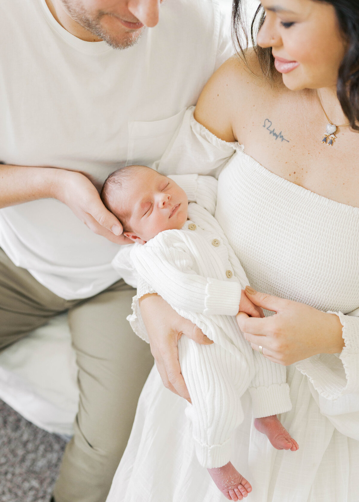 Mom and dad holding newborn baby in Virginia Beach newborn session