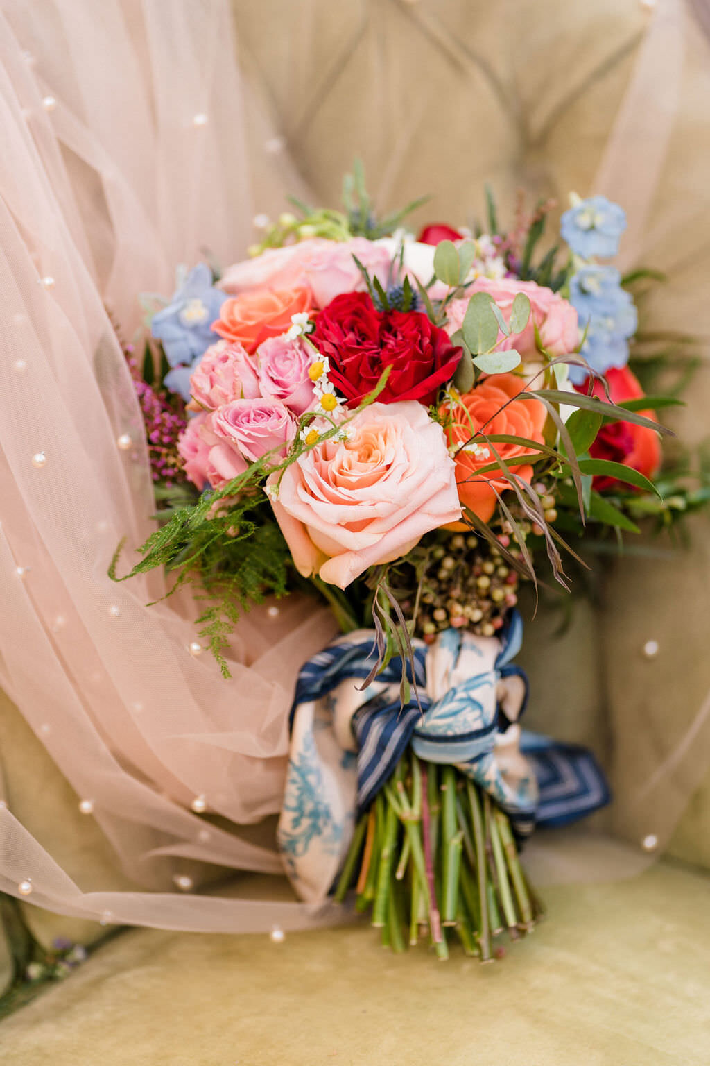 colorful bouquet of flowers sitting in a chair