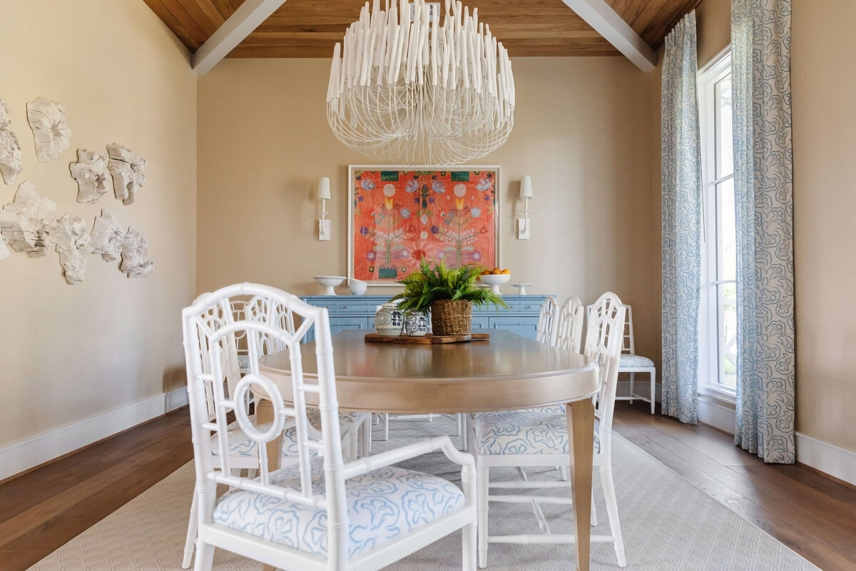 oyster creek studios memorial new build white chairs around wooden dining room table and chandelier in dining room
