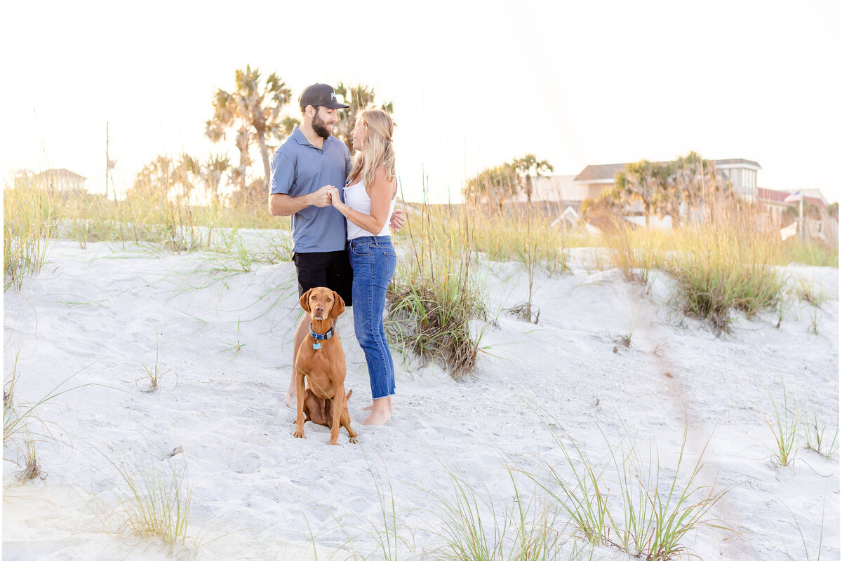 Couple with their dog on the beach during a mini session in Jacksonville Beach