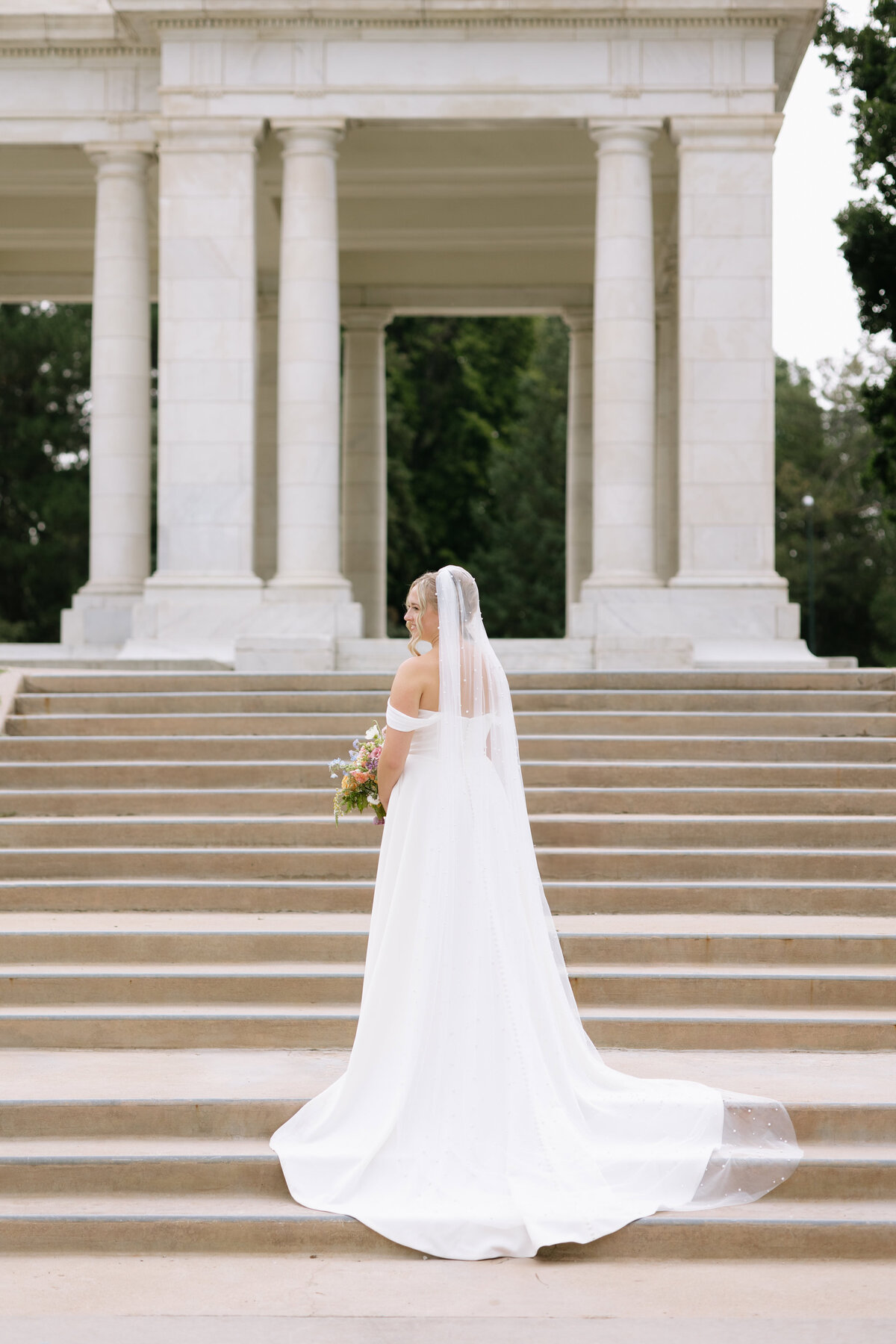 A bride poses for a photo at Cheesman Park in Denver, Colorado.