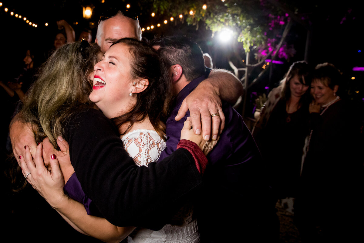 wedding-bride-hug-laugh-reception-candid-carmel