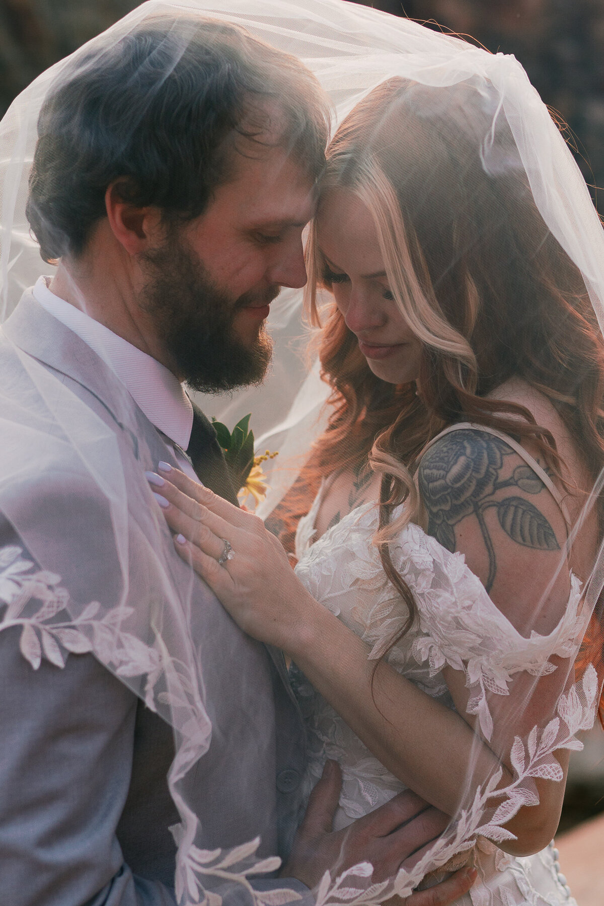 elopement-couple-quiet-moment-under-veil-tattoos