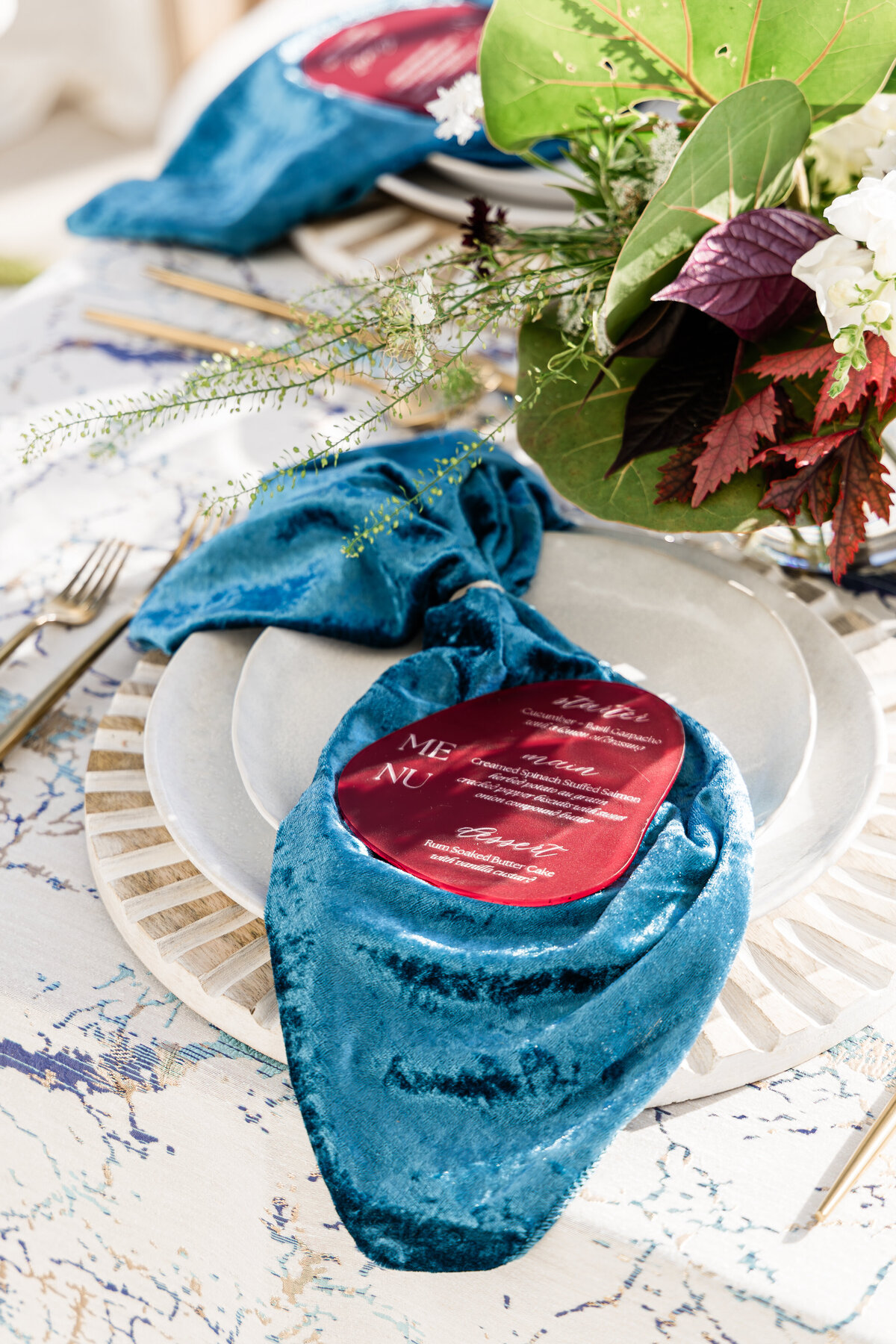 close up of nautical themed tablescape with seagrass centerpiece