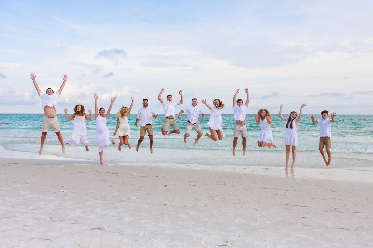 large multi-family photo of everyone jumping at The Inn at Crystal Beach in Destin, Florida.