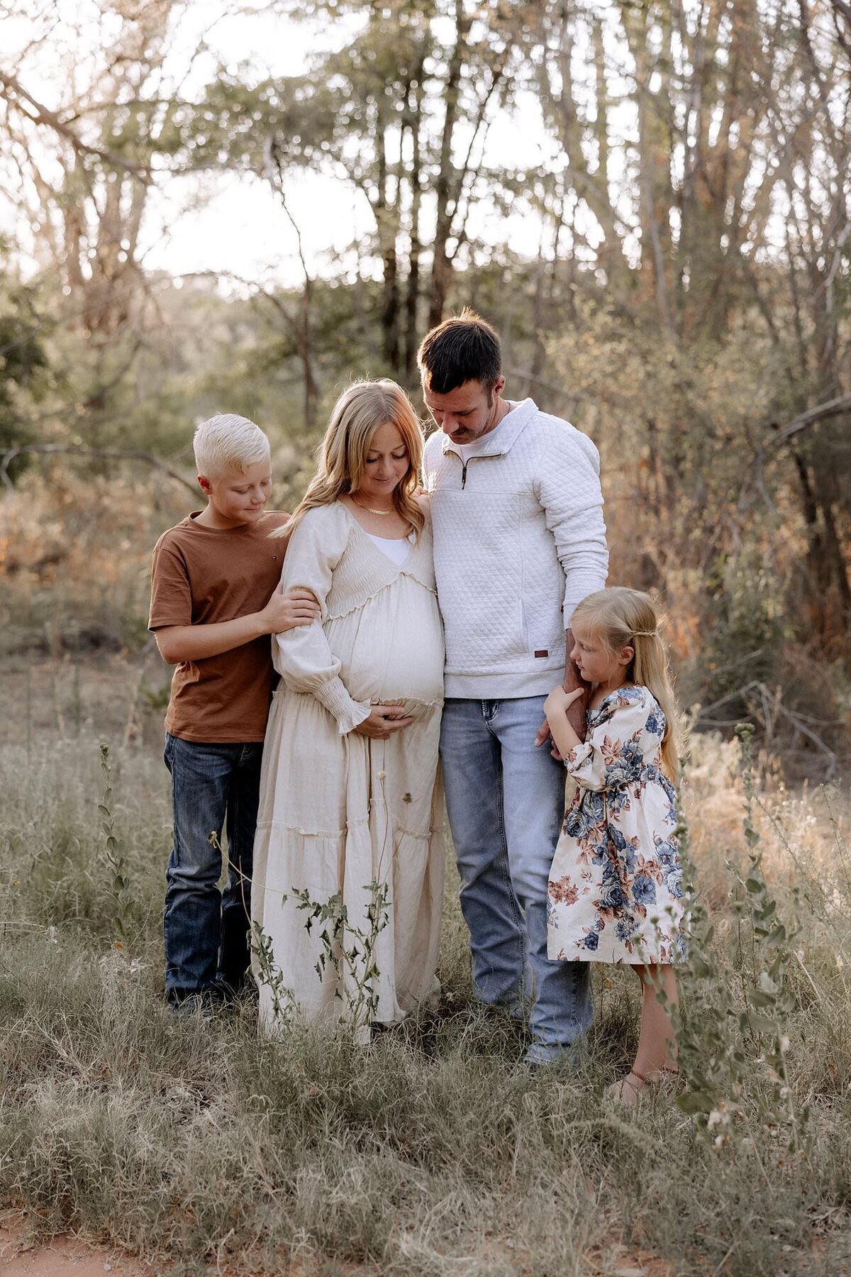 maternity photography in lubbock texas photo taken by mary wiebe photography of pregnant mama and her family in a wodded area