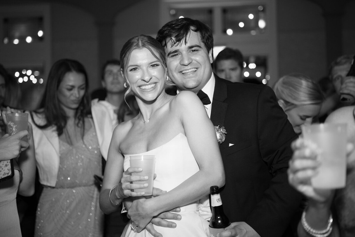 Black and white image of Callie and Hayes smiling and embracing on the dance floor during their Burritt on the Mountain wedding reception.