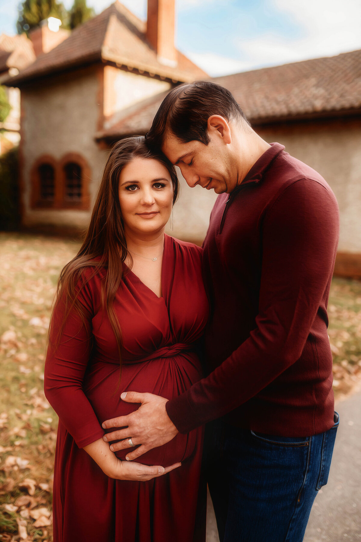 Pregnant parents embrace during for photos during Maternity Portrait Session at Biltmore Estate in Asheville, NC.