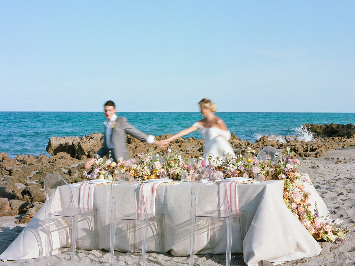 Bride and Groom run behind the tablescape.