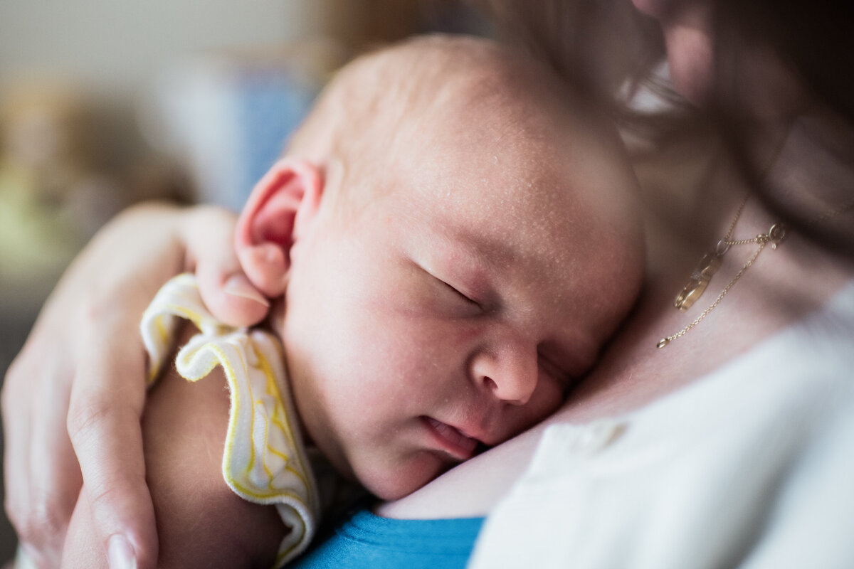 baby sleeping on mother during photos