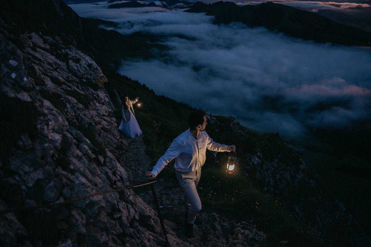Couple eloping in Switzerland by lantern as the sun sets