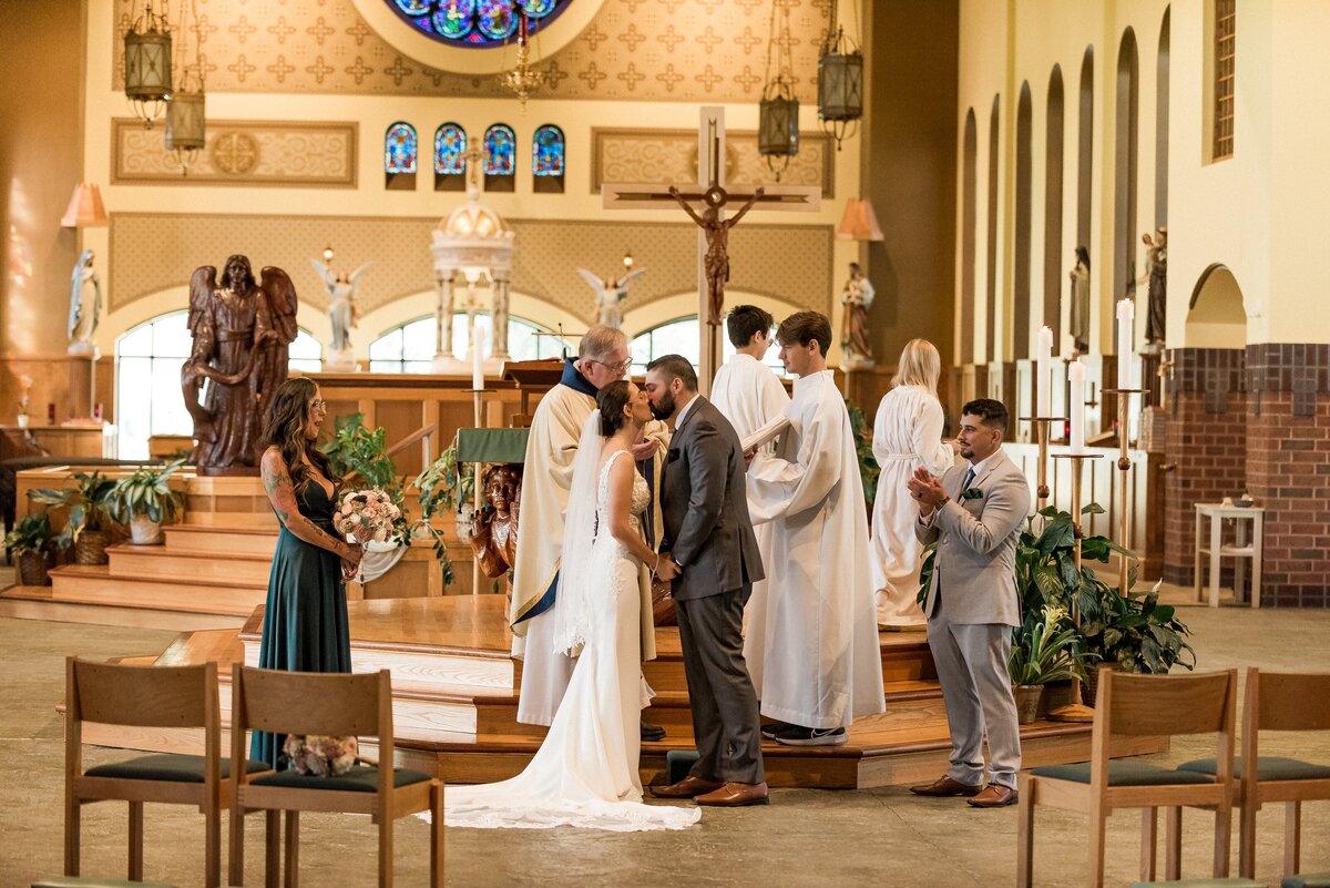Bride and groom leaving wedding in decorated car
