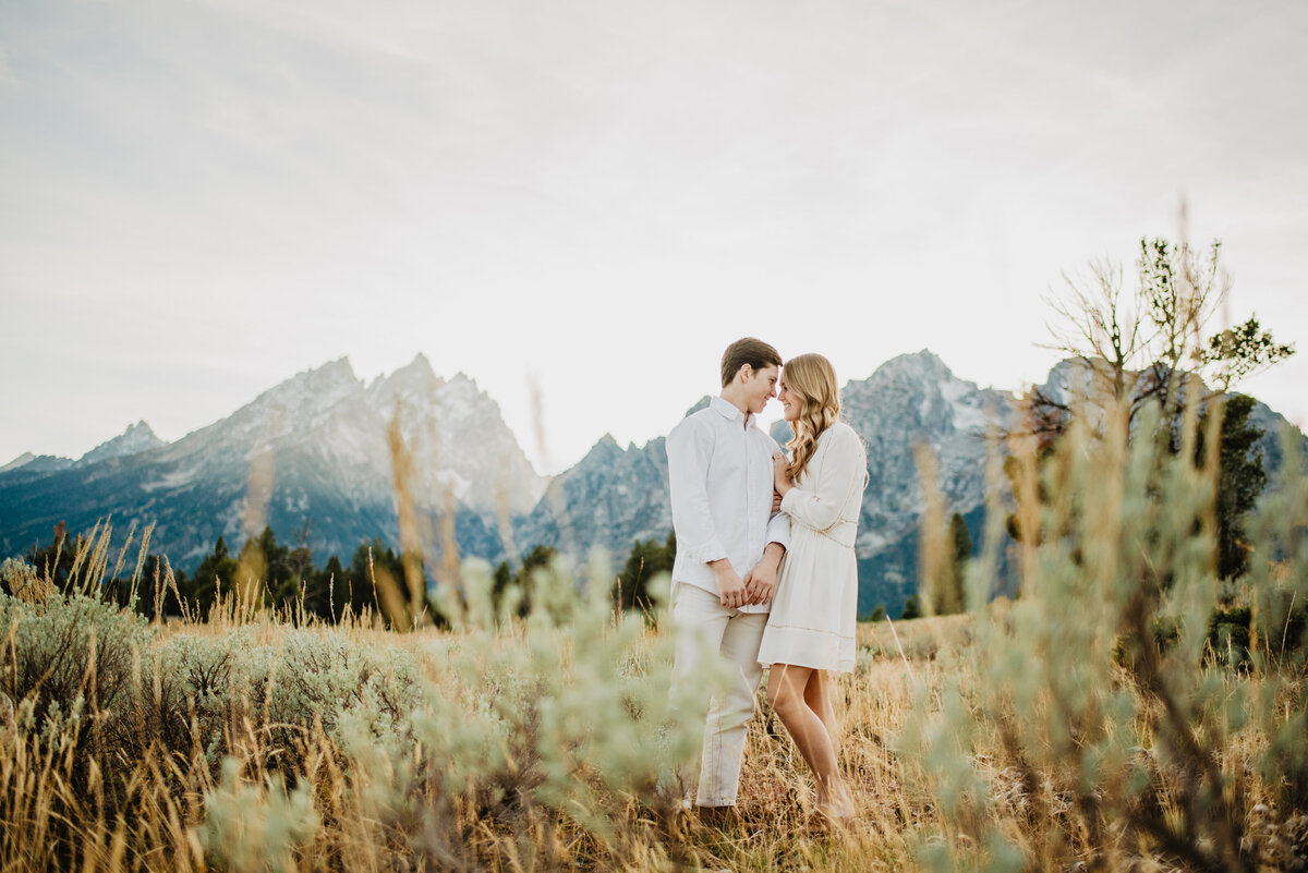 Photographers Jackson Hole capture couple standing together in front of tetons