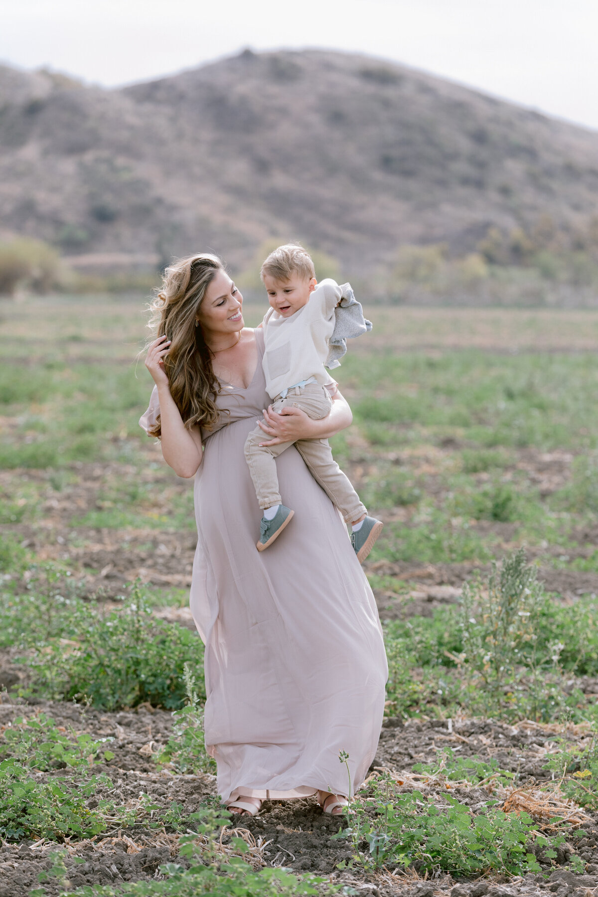 A mom holding their child on one hip