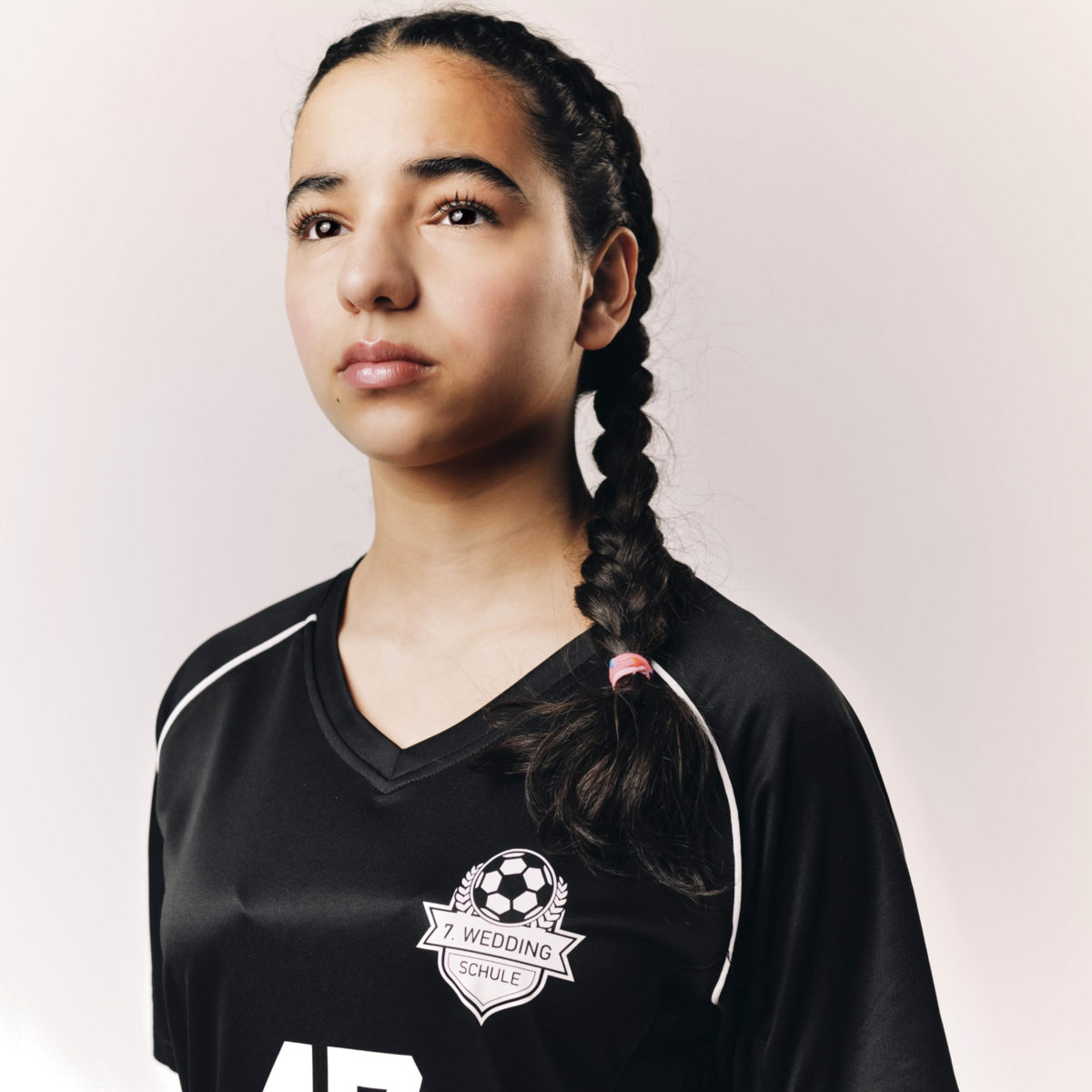 A character captured in profile, lit by a single soft source in a stylized frame.