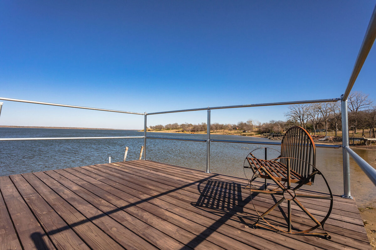 Fishing dock on Tradinghouse Lake at this 2-bedroom, 2-bathroom lakeside vacation rental home for 6 guests on Tradinghouse Lake with privacy access to a fishing dock and boat launch pad, ping pong table, gazebo, free wifi and free parking in Waco, TX.