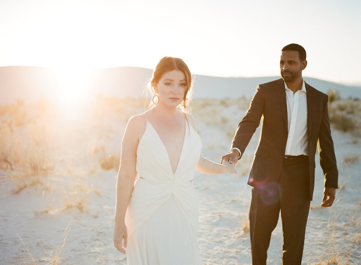 bride leading groom through white sands new mexico mo davis photography