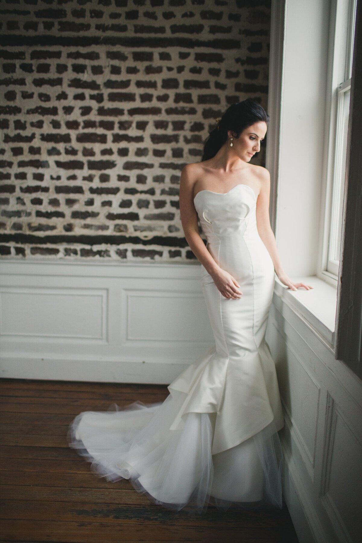 The petal shapes of this unique wedding gown accentuate the flare of the tulle mermaid skirt.