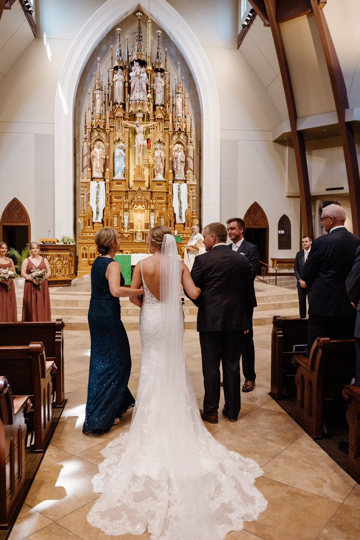Parents walking their child down the aisle at their wedding