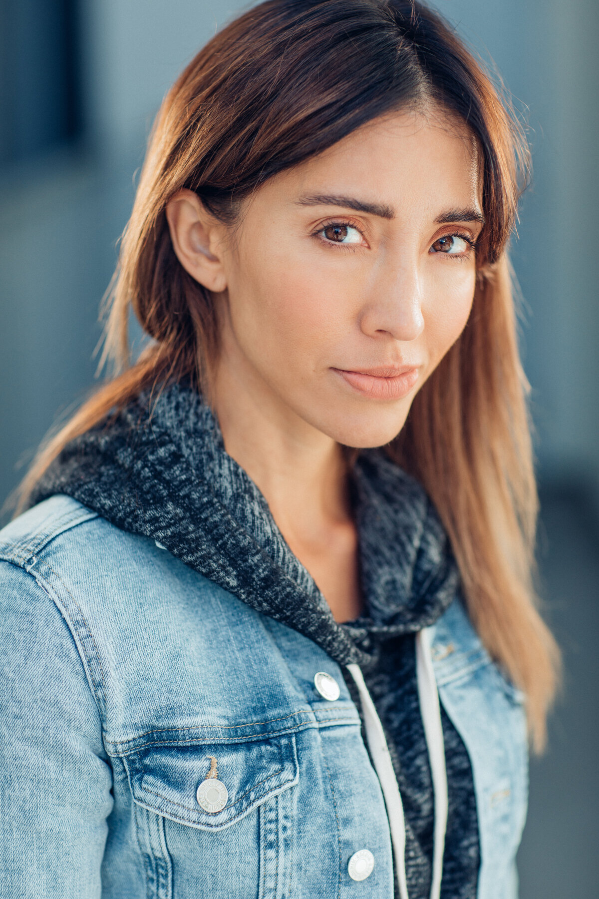 Headshot Photograph Of Young Woman In Outer Blue Denim Jacket And Inner Black Hoodie Los Angeles