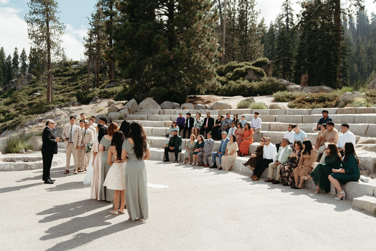 Glacier Point Amphitheater Wedding with guests all seated in the Amphitheater looking at the bride and groom