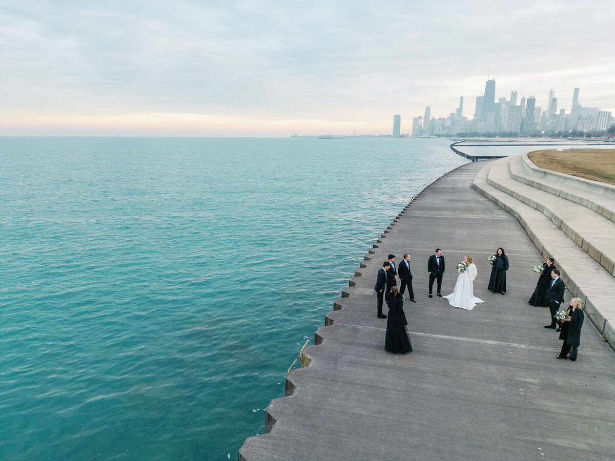 An overview shot of the bride standing in the center with the bridal party surrounding her with the city of Chicago in the background. 