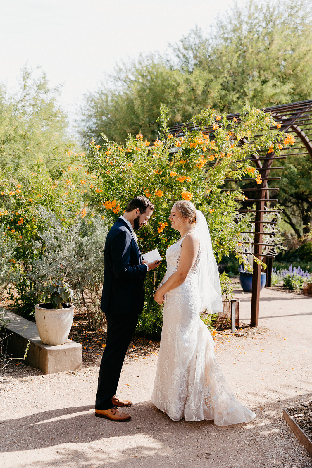 Wedding couple reading vows in the botanical gardens