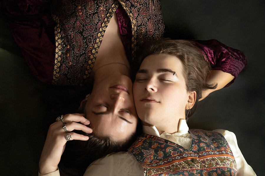 Newlyweds laying on floor with heads snuggled closely together and eyes closed.