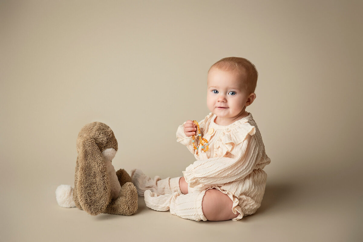 Baby girl with stuffed bunny.