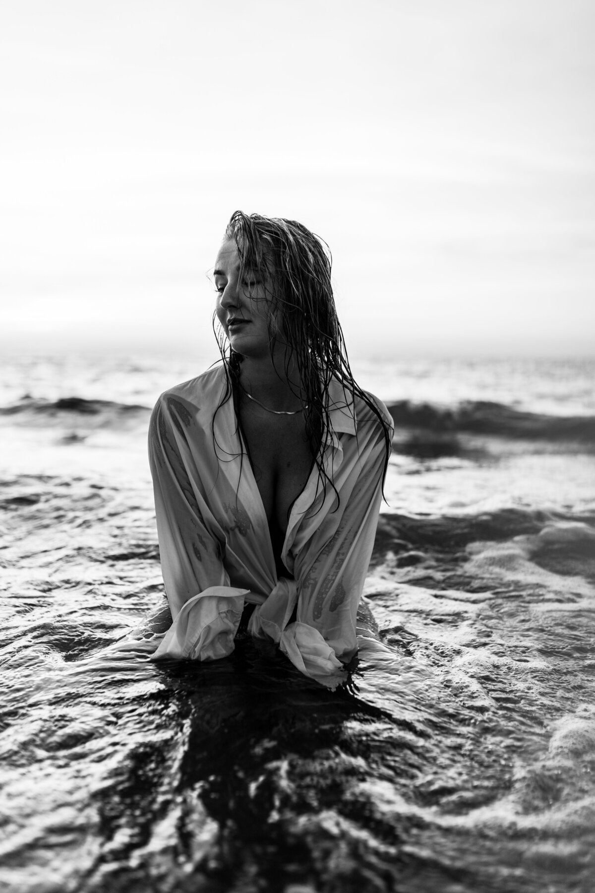 Fine art nude photography featuring soft shadows and natural lines.