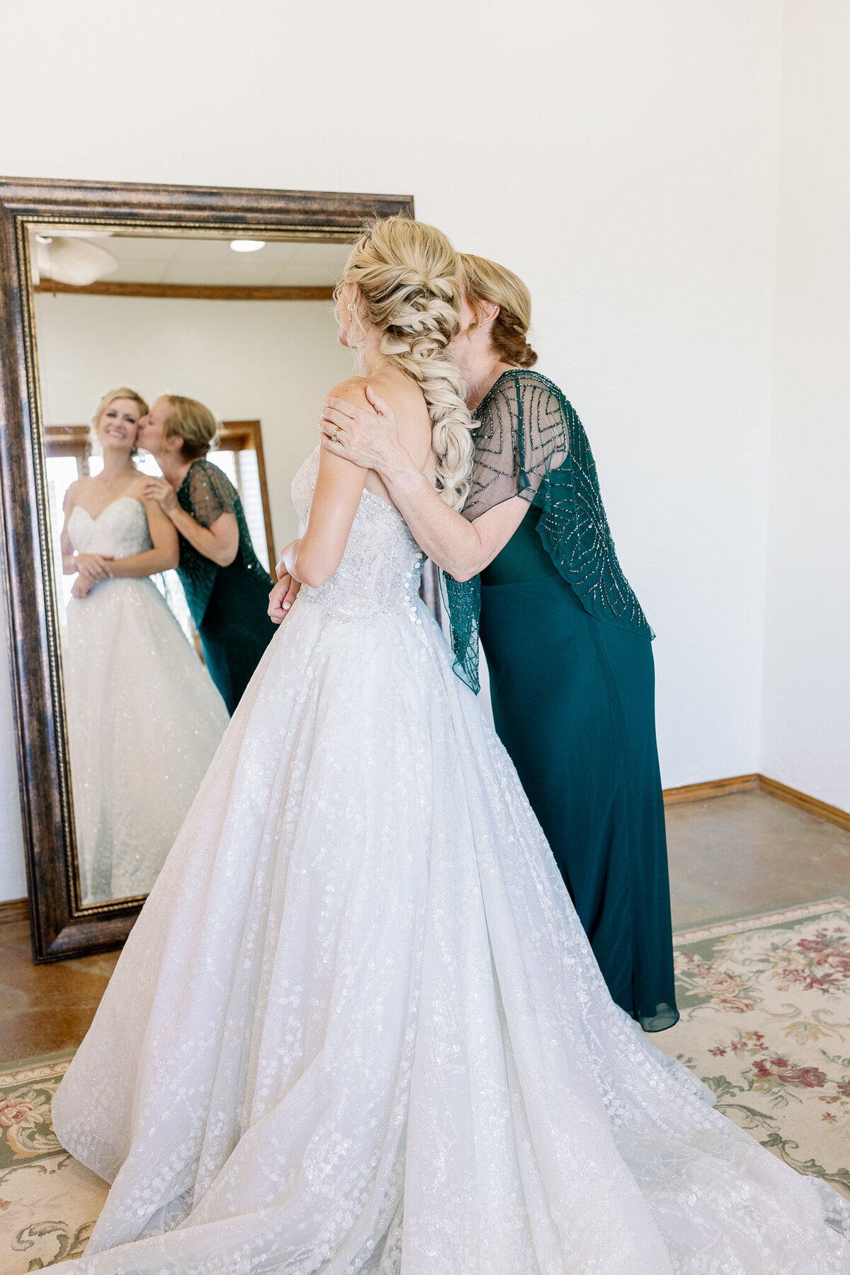 A candid moment shared between a bride and her mother 