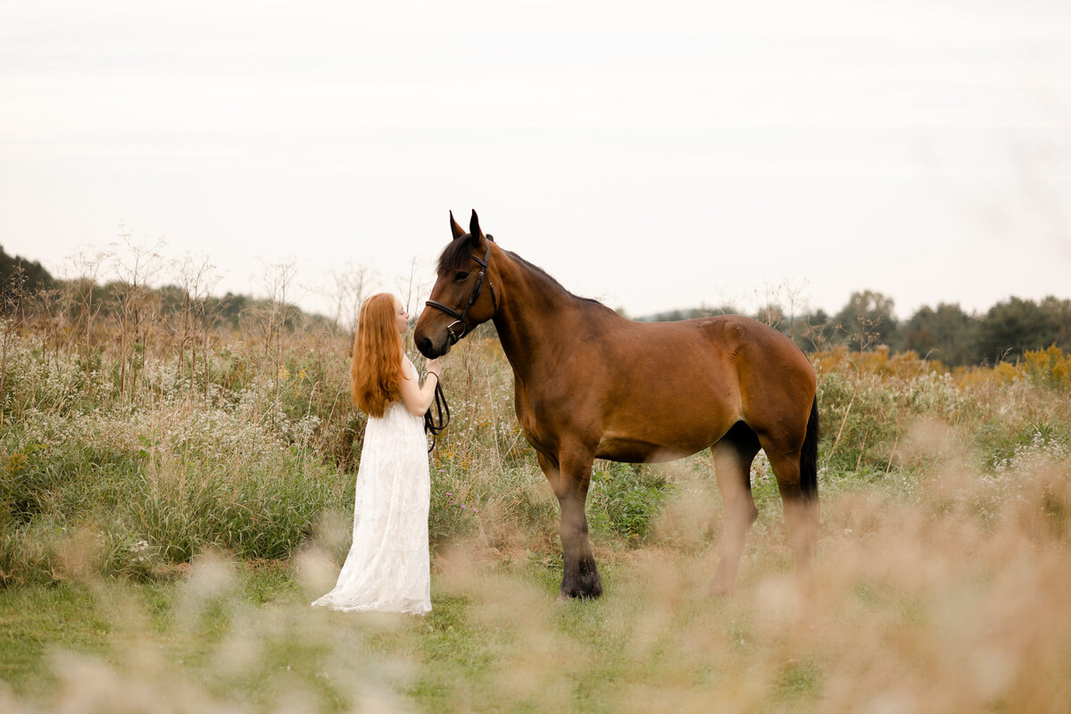 a girl and her horse share a sweet moment in a field of flowers 
