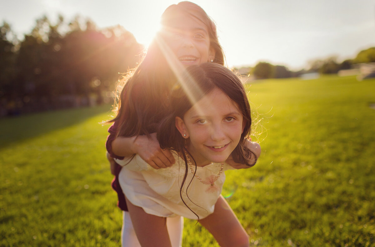 Sisters playing on the lawn in downtown Indy along the canal.