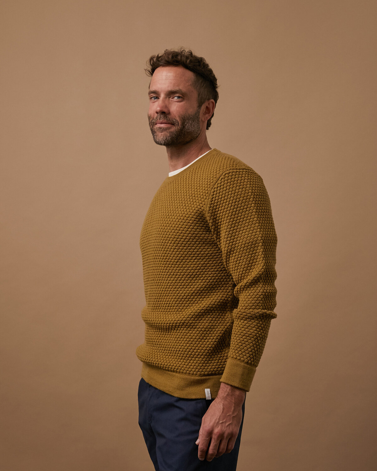 Picture of man in studio for sweater product