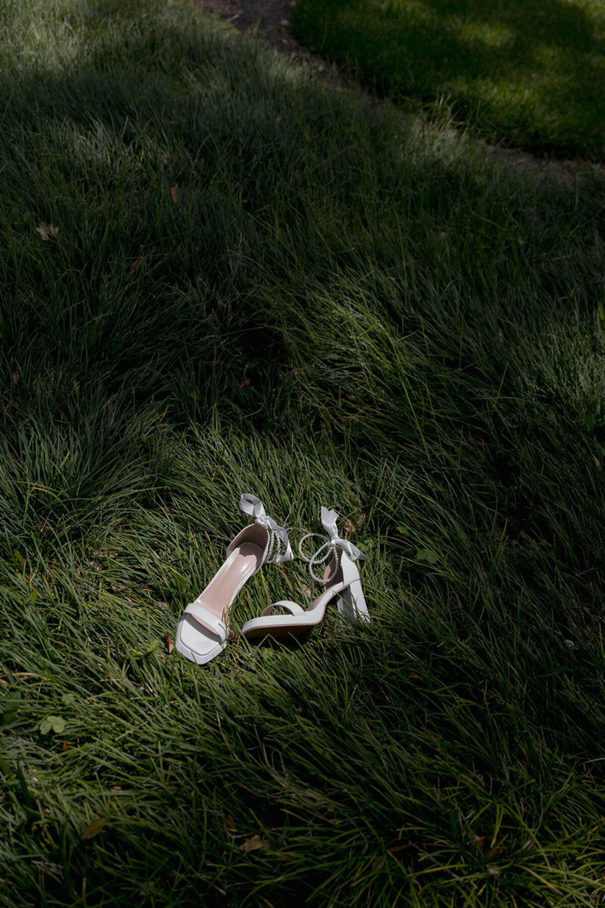 Wedding shoes in grass by photographer in orlando fl, Marissa Nicole