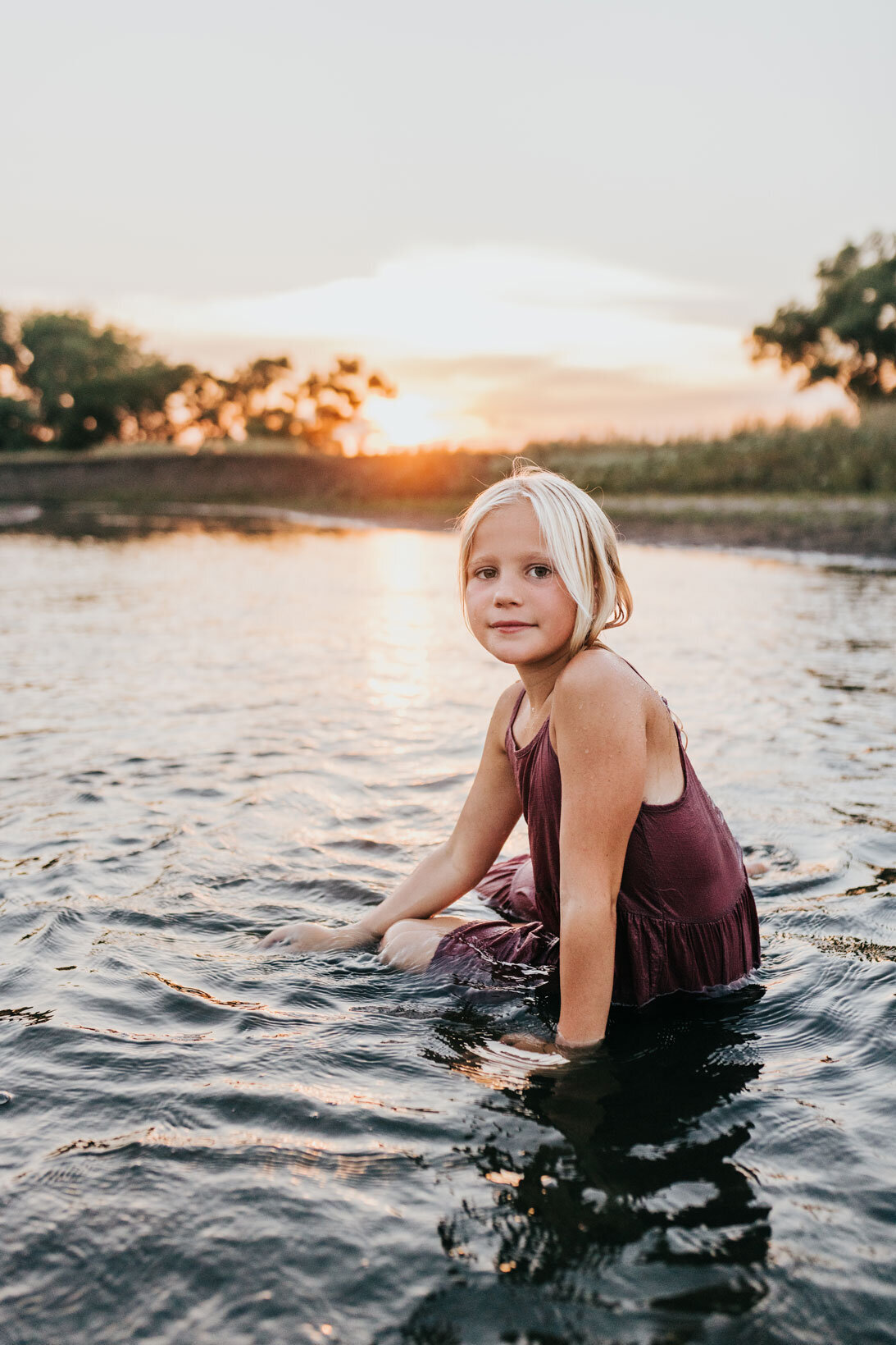 portrait-of-young-girl-in-creek-at-sunset