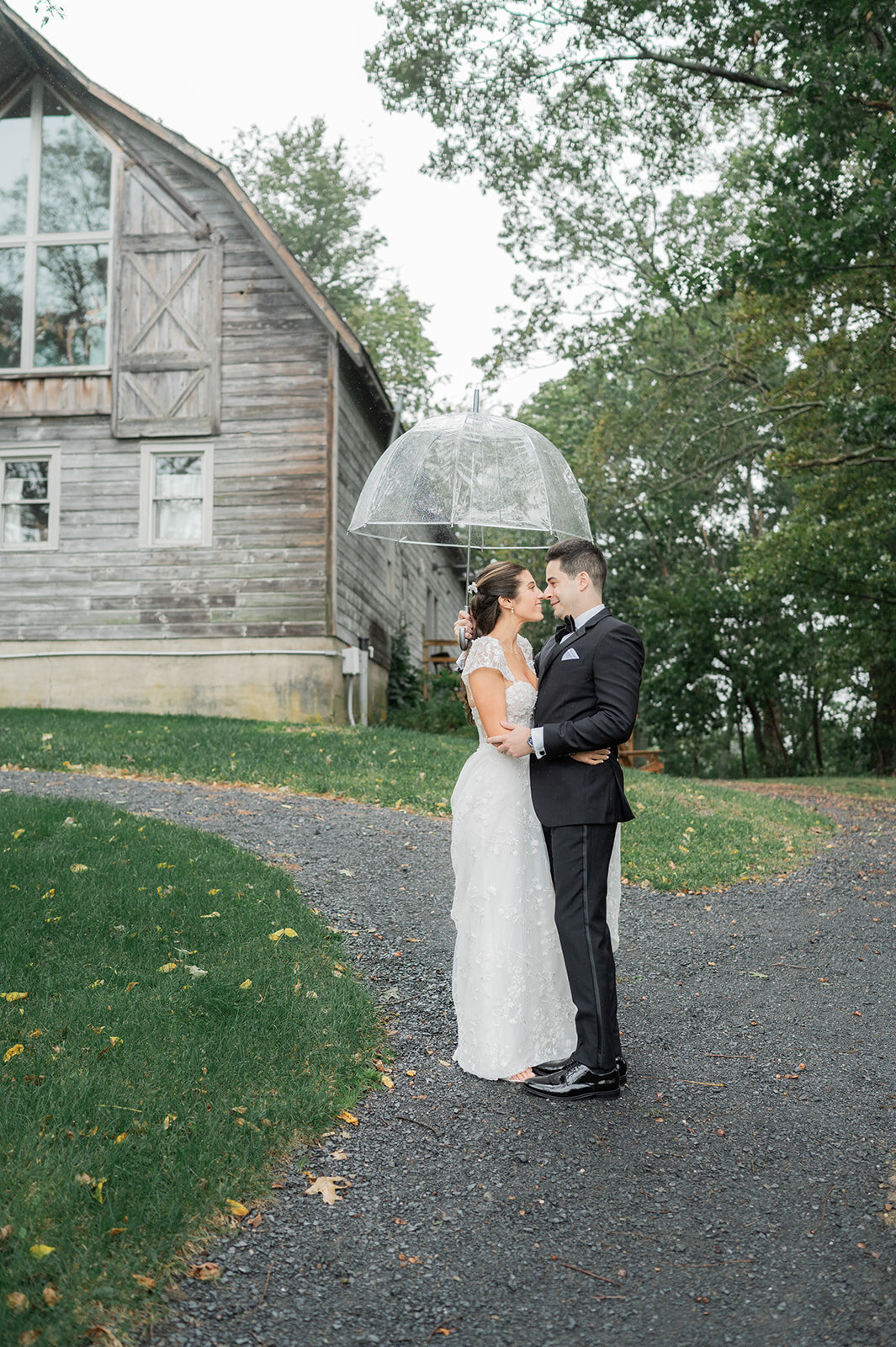 bride and groom share candid first look under umbrella