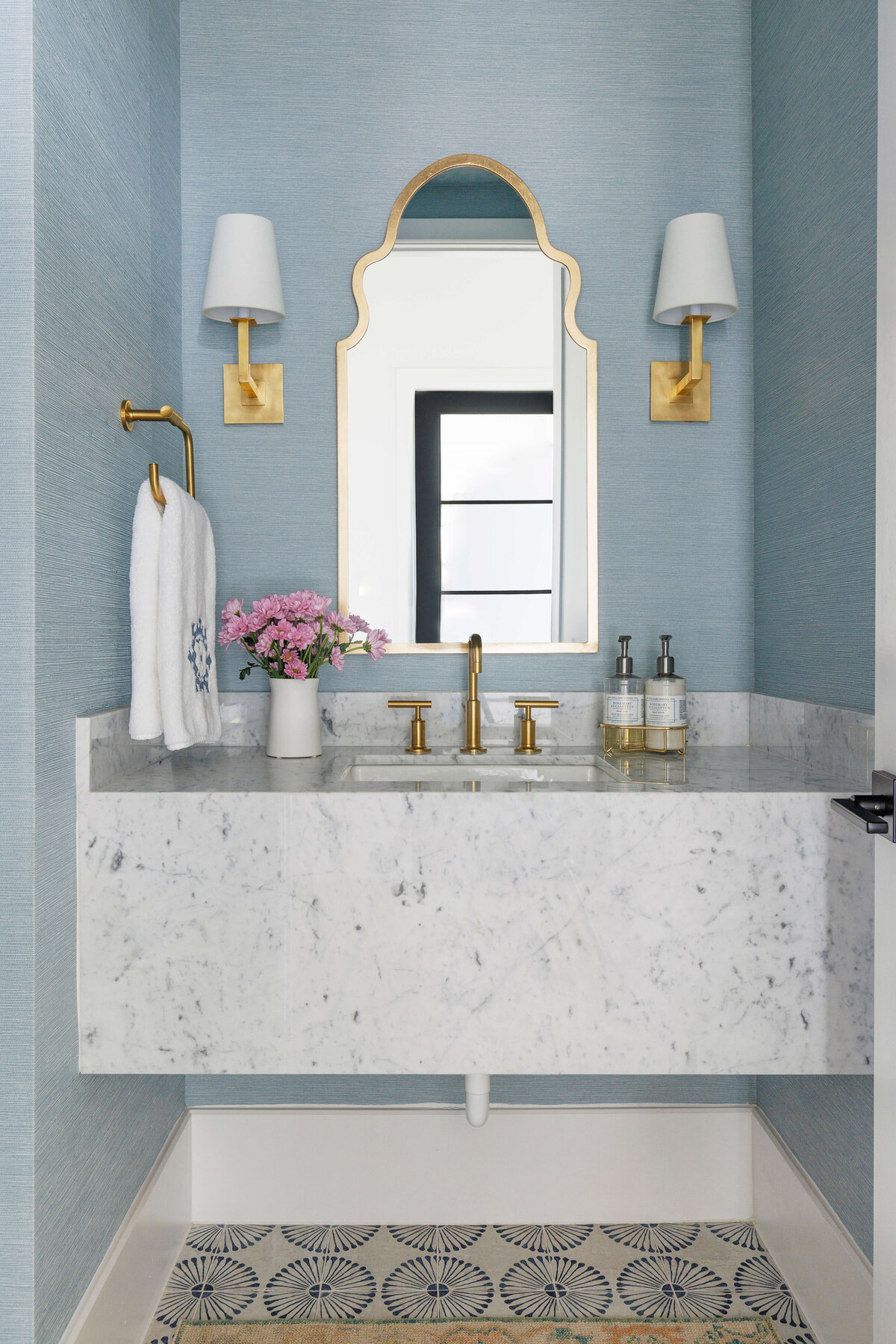 oyster creek studios missouri city new buildwhite marble vaniety with textured blue wallpaper gold hardware in bathroom